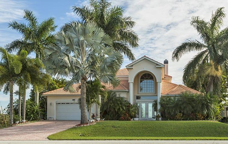 Protect Your Boynton Beach Home With Our Pest Control street view of a large boynton beach florida home and palm trees