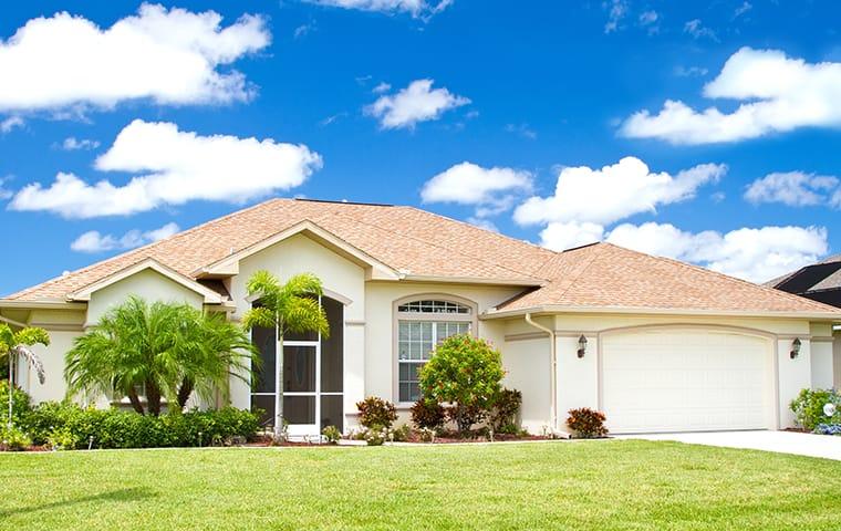 Our Services Will Keep Ticks Away From Your Home a street view of a large coral springs florida home