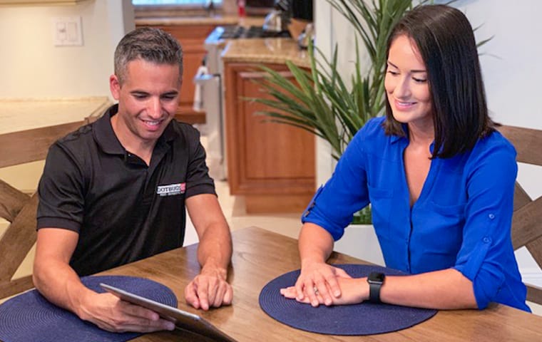 Our Experts Provide Advice For Keeping The Pests Away a homeowner meeting with a gotbugsikill service professional inside of a home in boca raton florida