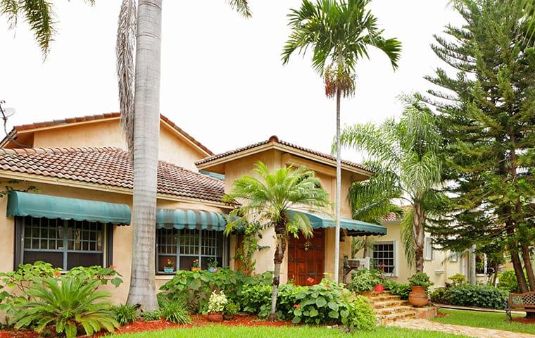 We Offer Year-Round Home Pest Control Programs street view of a large delray beach florida home and yard