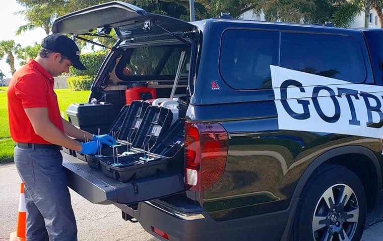 We Use No Dangerous Poisons When Eliminating Rodents a gotbugsikill service technician preparing rodent stations on the back of the company vehicle in boca raton florida