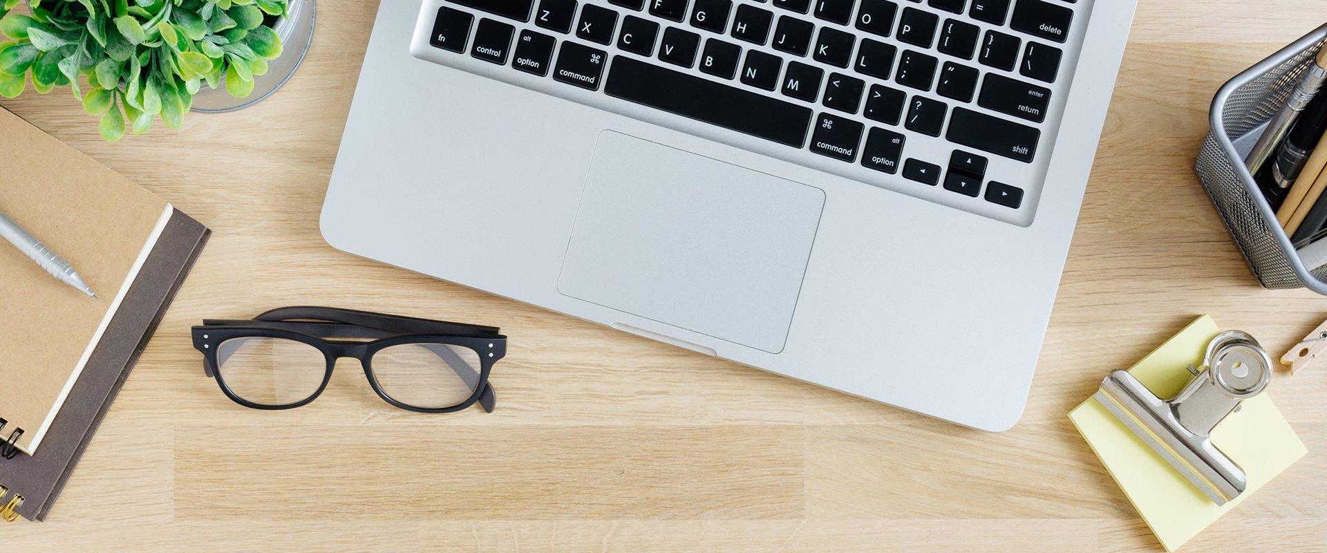 a laptop and glasses on a table