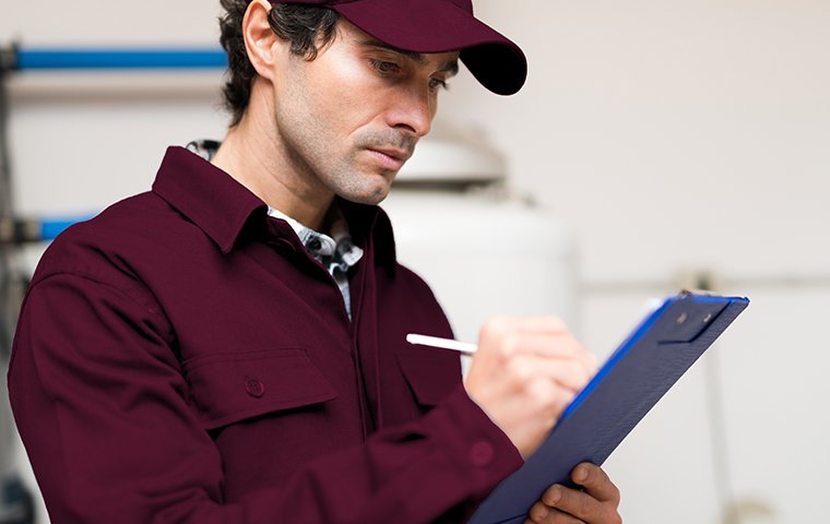 tech inspecting with a clipboard