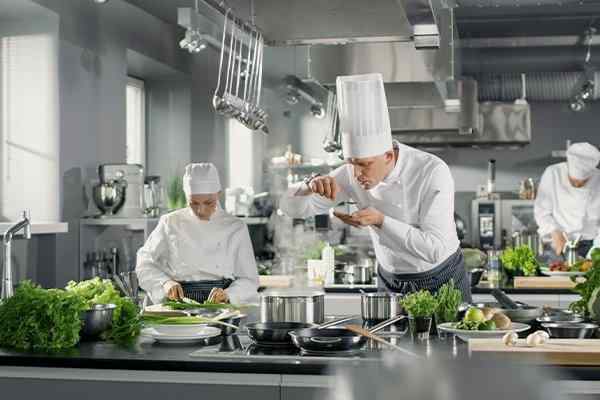 commercial kitchen interior with chefs at work