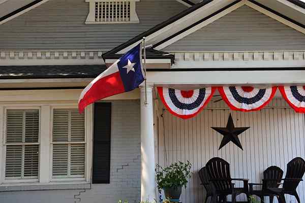 house with texas flag hanging on fron porch