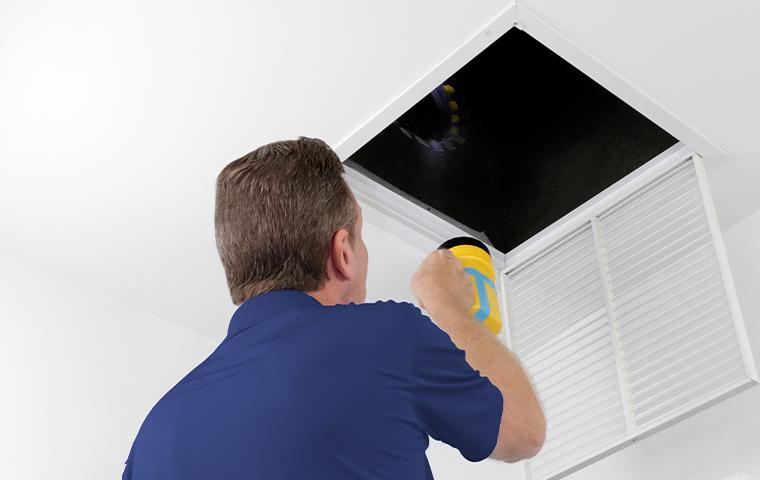 tech inspecting vent
