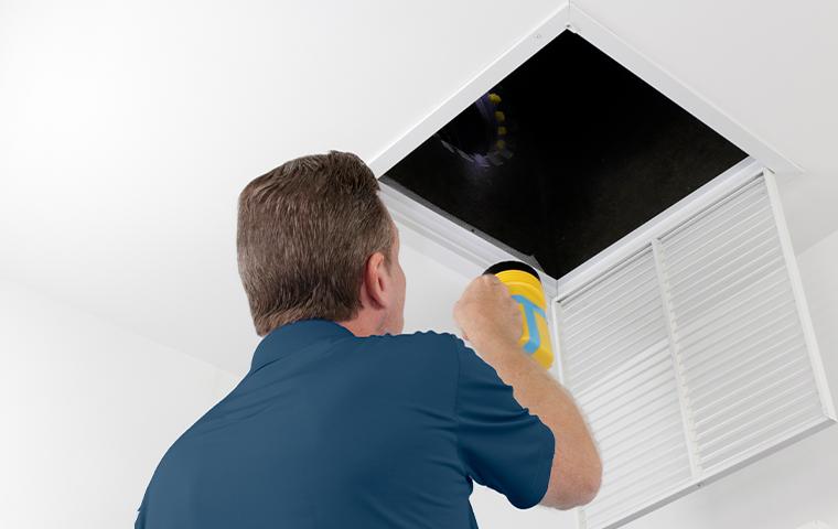 technician inspecting vent