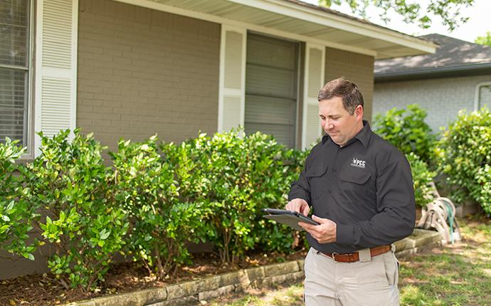 We Offer Quality Pest Control Inspections pest control consultants technician inspecting a saint charles illinois property for pest activity