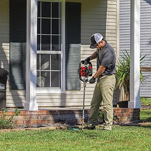 tech servicing exterior of home