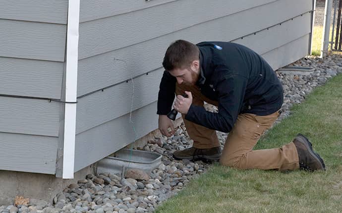 Prosite Keeps Your Family Safe From Pests prosite pest control service expert inspecting the exterior of a home in central washington