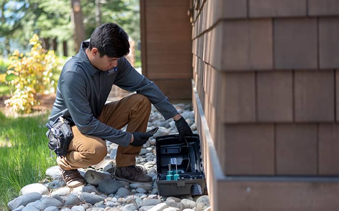 Keep Rodents Away With A Prevention Plan a prosite pest control service expert performing rodent control services outside of a home in washington
