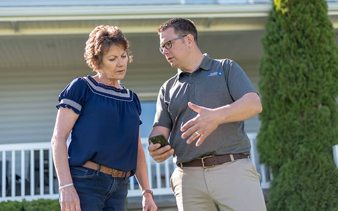 Prosite Protects Your Home Year-Round From Pests a prosite pest control service expert with a residential homeowner in sunnyside