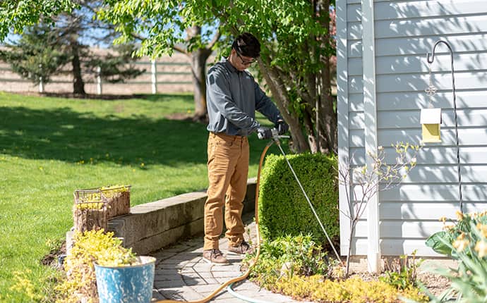 Prosite Offers A 7-Year Termite Warranty a prosite pest control service expert digging a trench around a central washington home