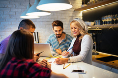 Pest Free Professionals: Bug Busting Tips to Teach Your Employees Smiling workers standing together in a circle around a laptop in a well-lit room