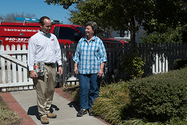 Learn How Year-Round Pest Control Can Help Protect Your Home And Family From Pests technician with customer