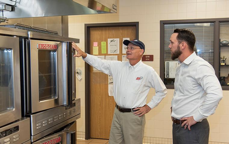 business manager with adams tech inspecting for pests