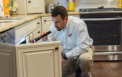 adams technician inspecting residential kitchen