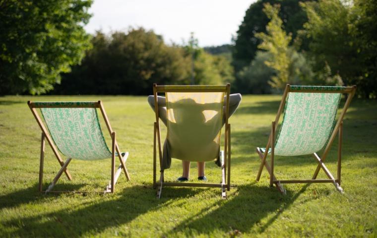 woman relaxing in a lawn chair in backyard