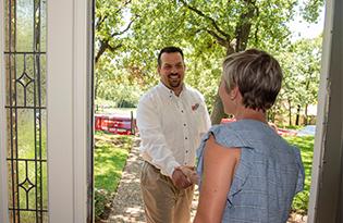 technician greeting homeowner