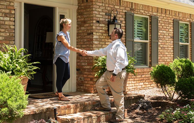 adams tech greeting homeowner at door of house in the colony texas