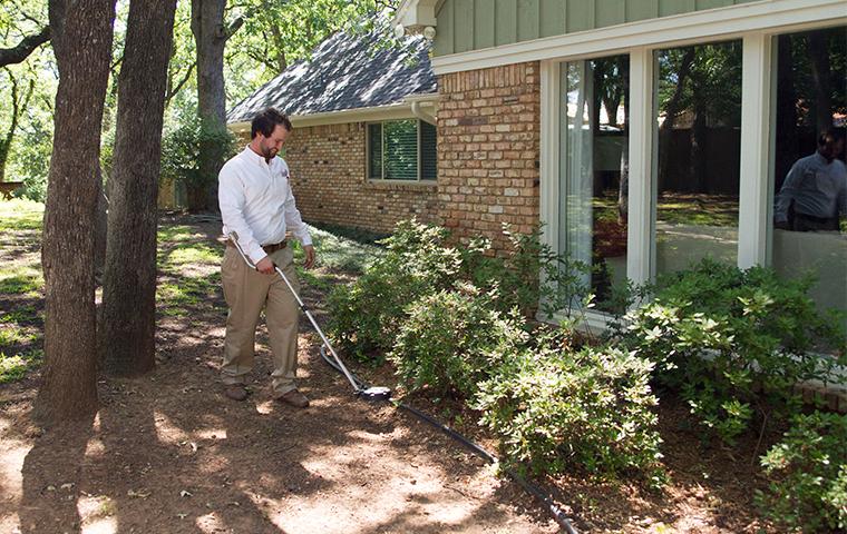 adams tech inspecting for termites around a trophy club tx home