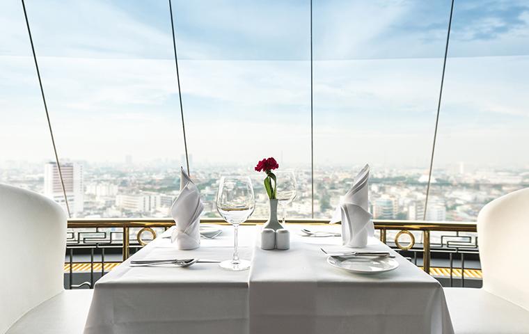 white themed restaurant table with city view