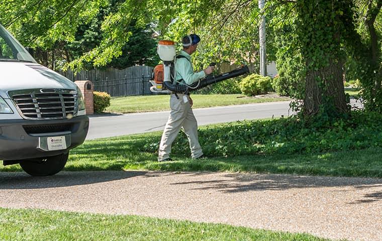 technician spraying for mosquitoes