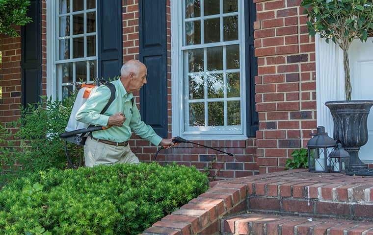 Learn More About Spider Control In Arrington TN all american tech providing an exterior treatment to reduce spiders outside of arrington tennessee home