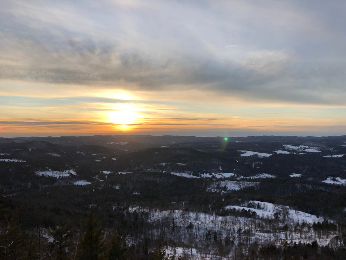 A golden and blue sunset spreads over the valley in a view from Wright's Mountain.