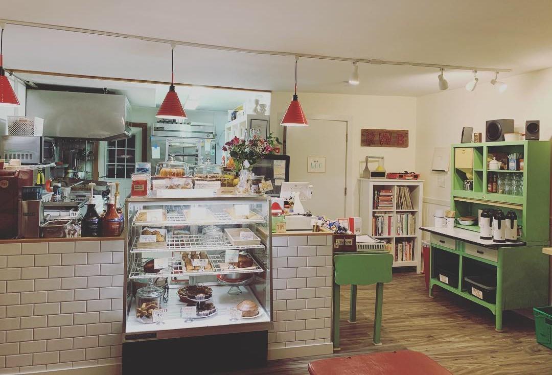 The view of the inside of Red Wagon Bakery, facing the case of baked goods and the cash register.