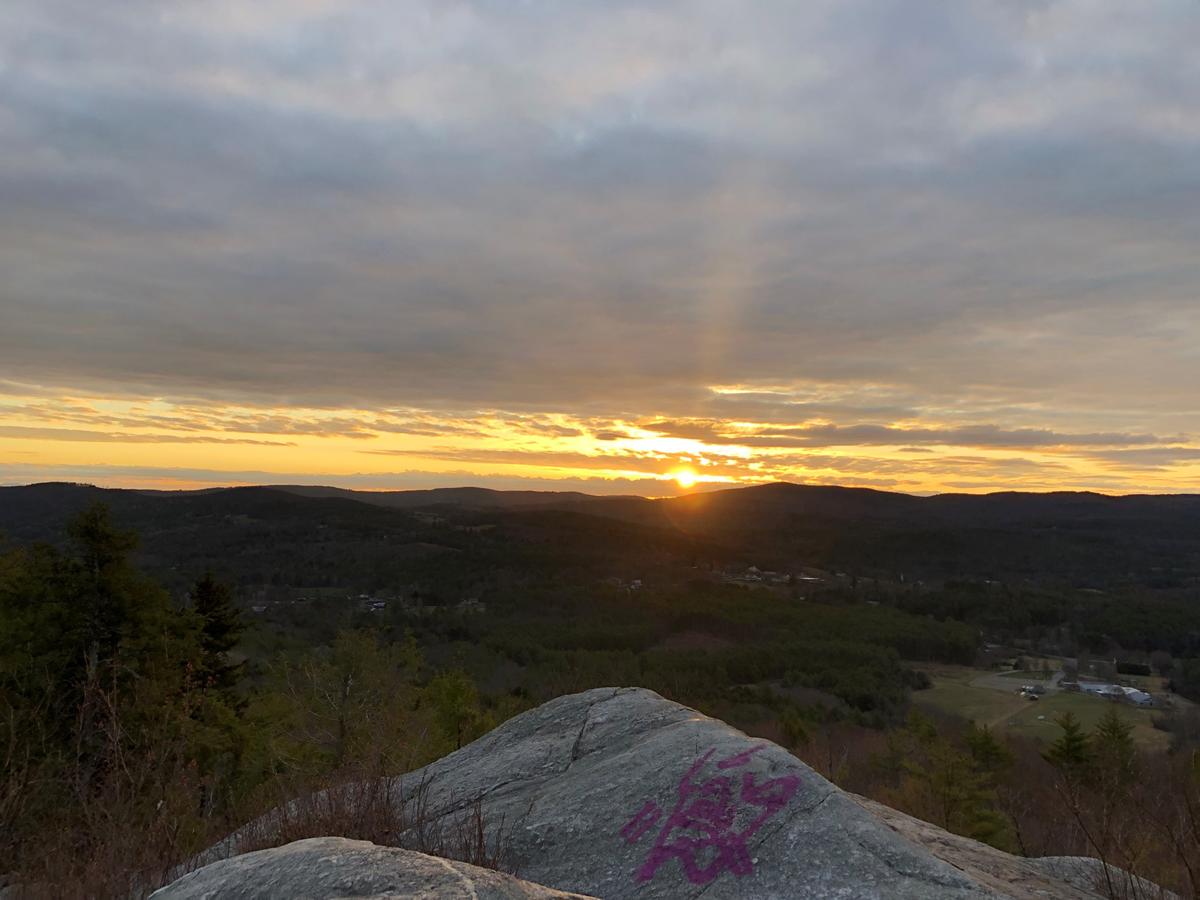 The sun peeks over the horizon in the view from French's Ledges