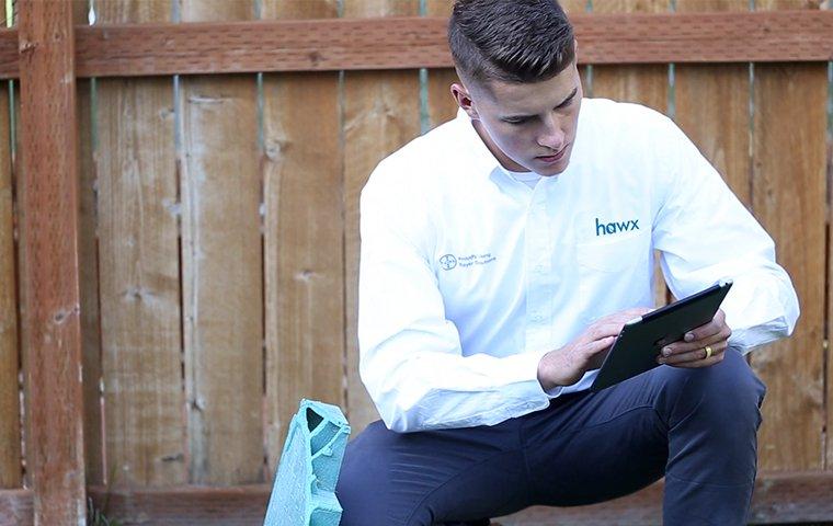 a pest control service technician reviewing his service visit