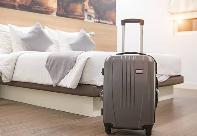suitcase in a hotel room that could potentially have bed bugs in it