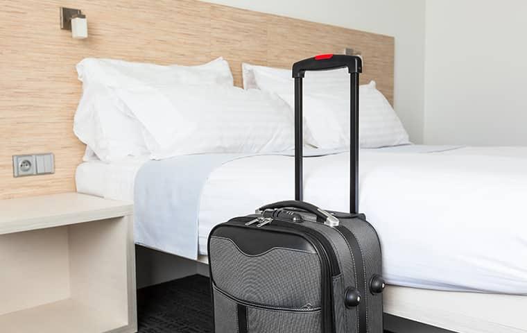 suitcase in front of a hotel bed