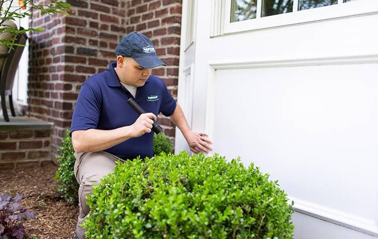 Learn About The Exclusion Services Parkway Pest Services Offers parkway tech inspecting outside of new york home