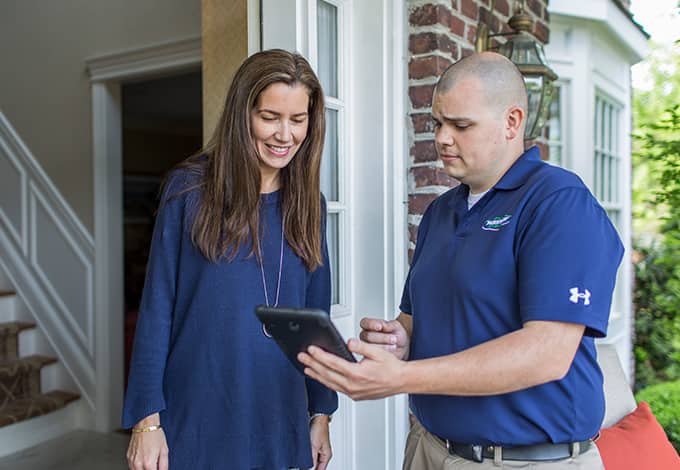 atlantic beach ny pest control technician explaining service to customer