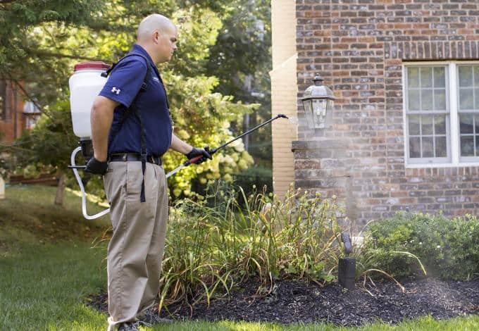 Stop Mosquito Bites With Help From Parkway long island pest control tech treating yard for mosquitoes