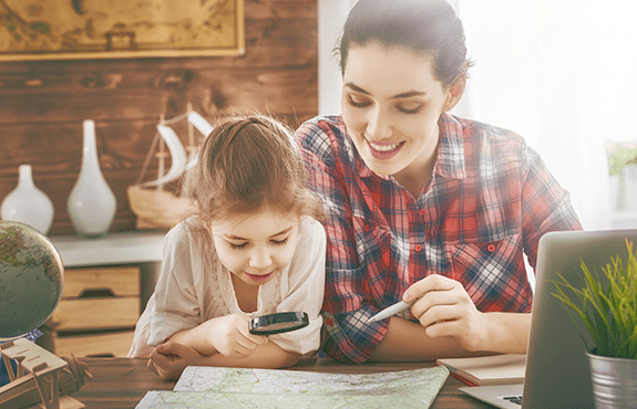 mother and daughter looking at maine map