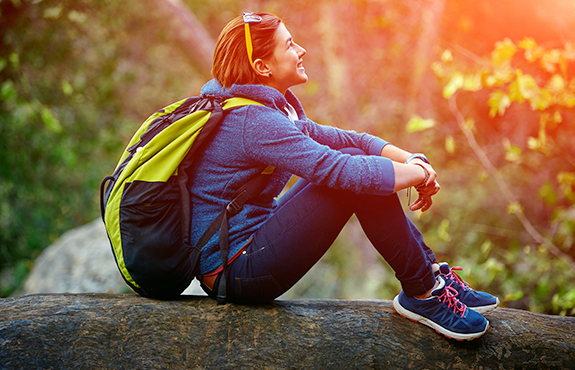 woman taking a rest to while hiking in maine