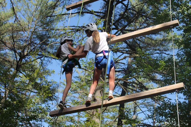 Girls enjoy the ropes course at Camp Tapawingo, Maine