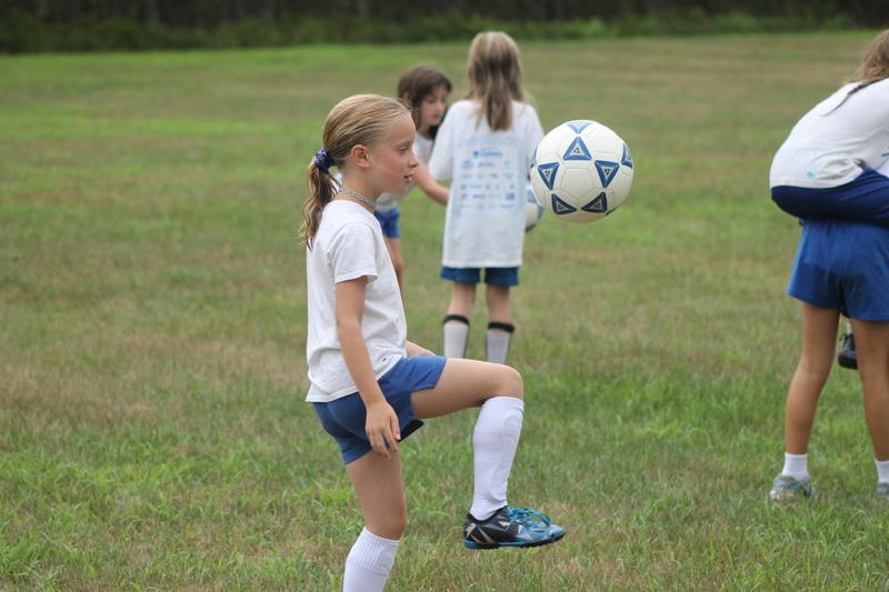 A camper shows her soccer skills at Camp Tapawingo, Maine