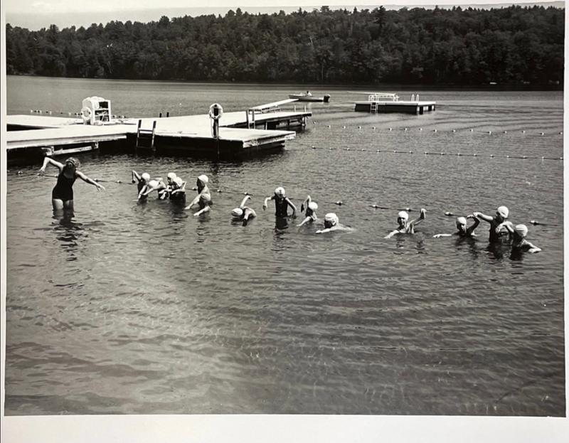 A vintage photo shows girls learning to swim at Camp Tapawingo, Maine