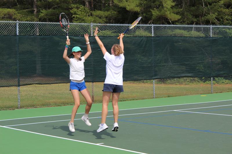 Tapawingo girls celebrate on the tennis court