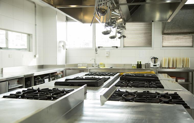 commercial kitchen with gas range stoves
