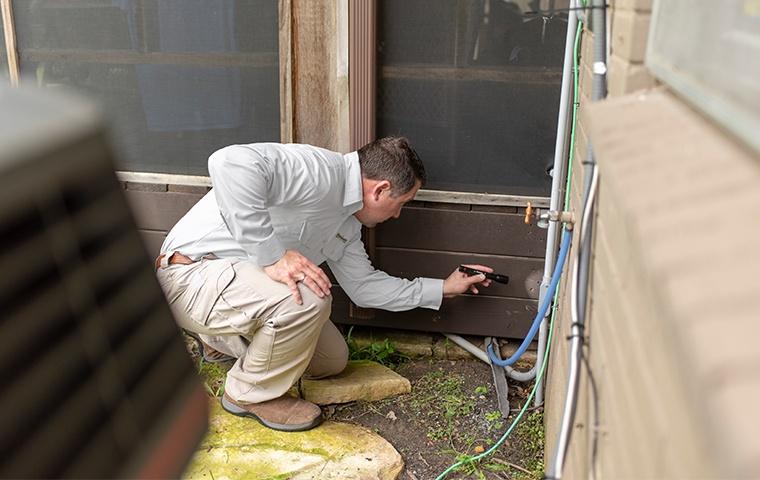 a pest control service technician inspecting the interior of a home in manhattan new york