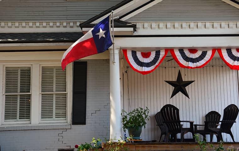house with flag and banners on porch