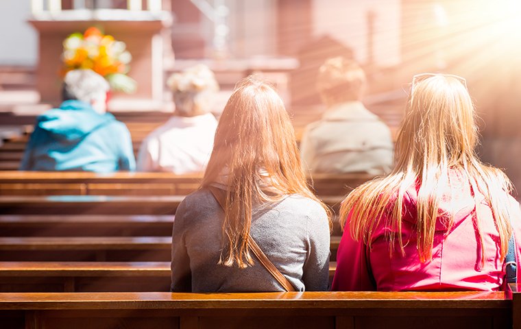 people sitting in church pews inside a memphis church