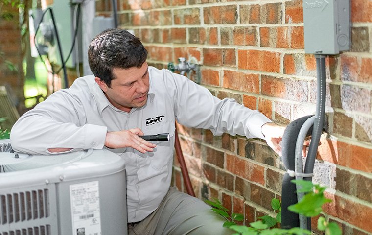 a pest control technician inspecting entry points for pests at a home in memphis tennessee